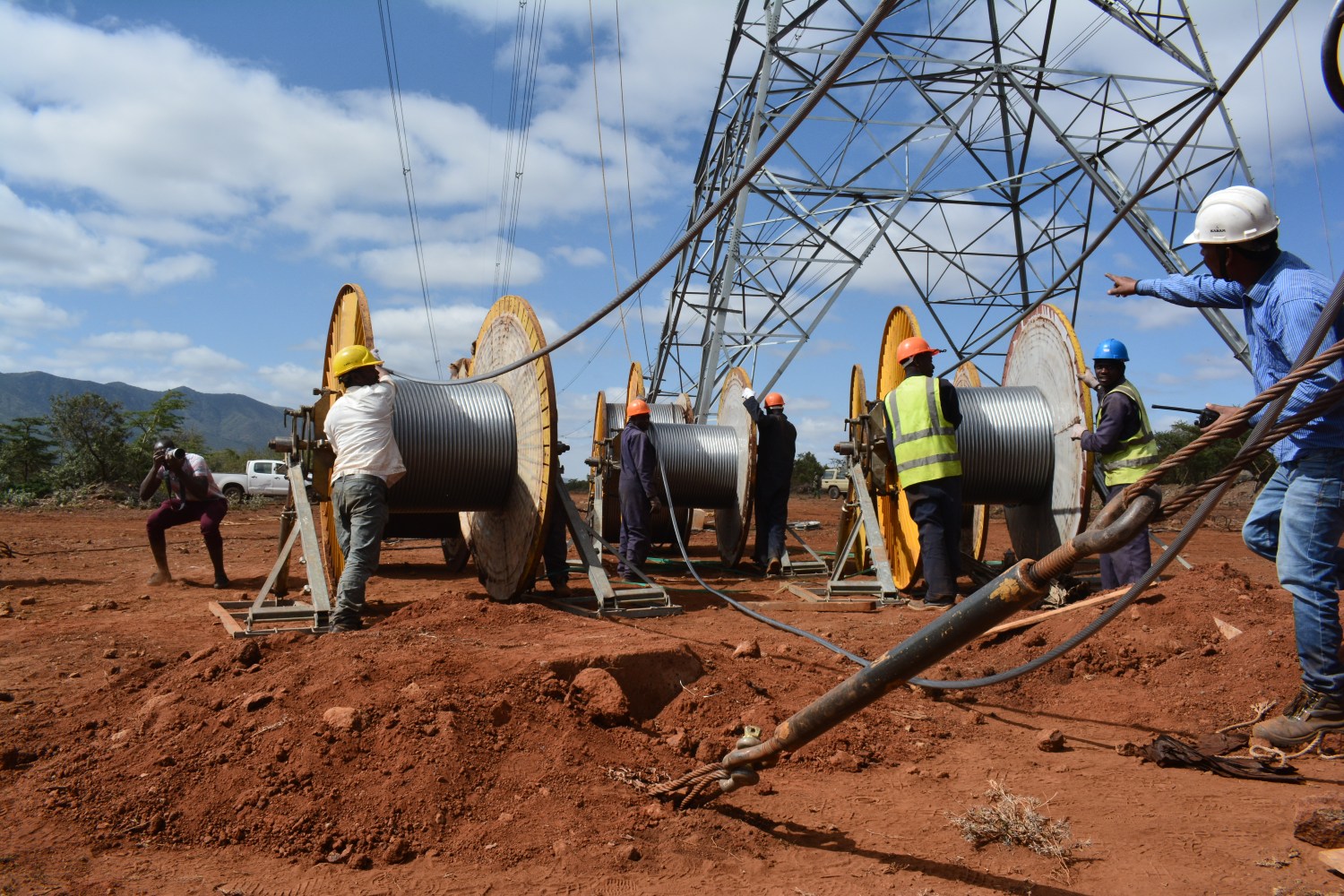Nairobi, Kenya -June 13th 2017: Electric engineers laying down Electric transmission lines in rural Kenya, Africa. This lines transmit high power electricity to different regions countrywide.