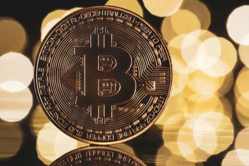 Golden bitcoin with yellow bokeh background