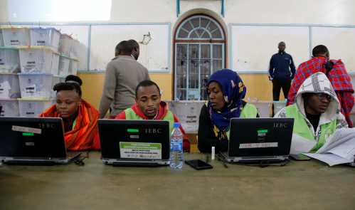 Election officials work at computers at a tallying center in Nairobi, Kenya.
