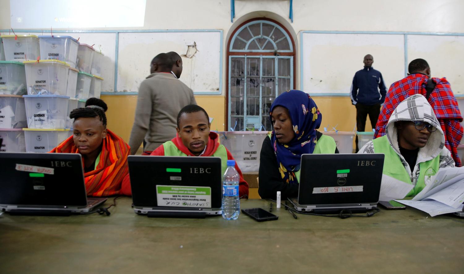 Election officials work at computers at a tallying center in Nairobi, Kenya.