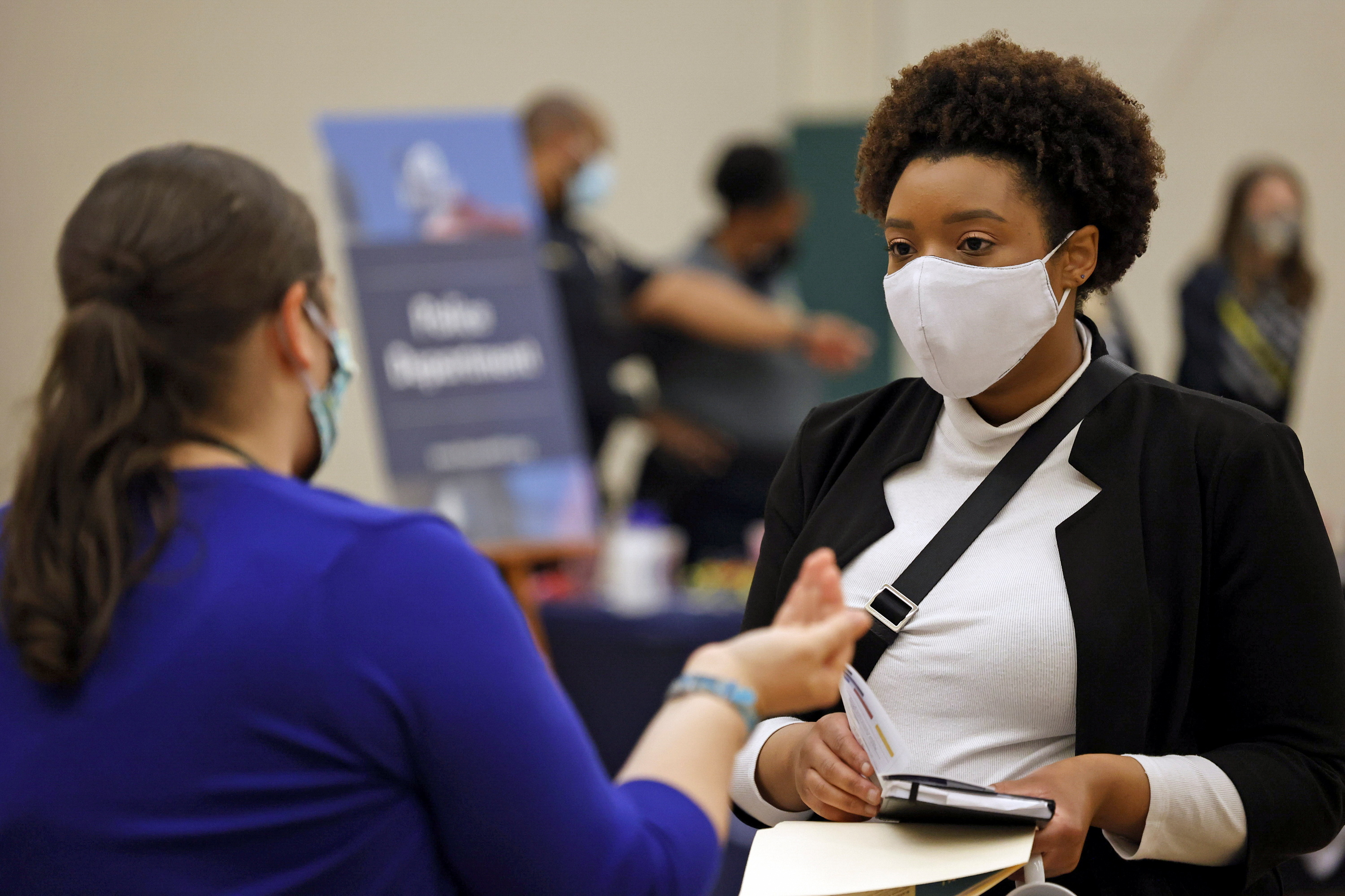 Britni Mann speaks with a potential employer during a job fair at Hembree Park in Roswell, Georgia, U.S. May 13, 2021.   REUTERS/Chris Aluka Berry