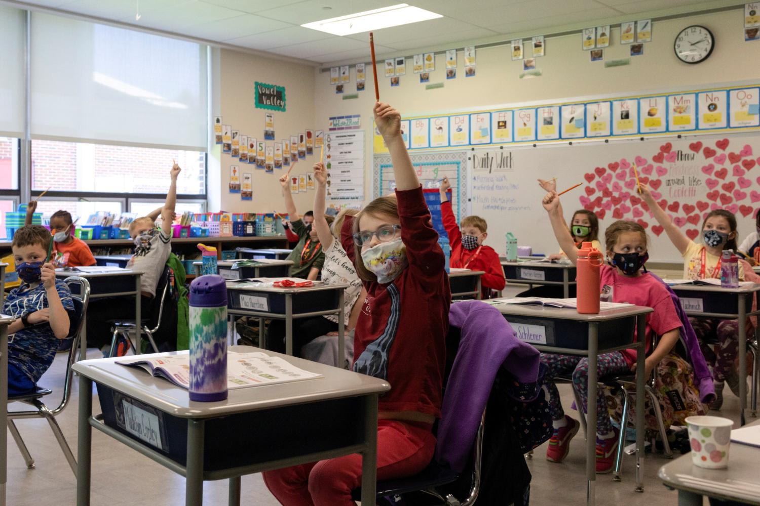FILE PHOTO: Students raise their hands to answer a question at Kratzer Elementary School in Allentown, Pennsylvania, U.S., April 13, 2021.  REUTERS/Hannah Beier/File Photo