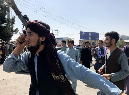 A member of Taliban forces inspects the area outside Hamid Karzai International Airport in Kabul, Afghanistan August 16, 2021. REUTERS/Stringer NO RESALES. NO ARCHIVES     TPX IMAGES OF THE DAY