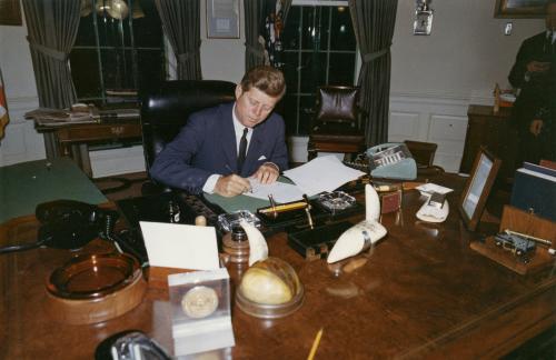 Former U.S. President John F. Kennedy signs a proclamation for the interdiction of the delivery of offensive weapons to Cuba during the Cuban missile crisis, at the White House in Washington in this handout photograph taken on October 23, 1962. November 22, 2013 will mark the 50th anniversary of the assassination of Kennedy. REUTERS/Cecil Stoughton/The White House/John F. Kennedy Presidential Library (UNITED STATES - Tags: POLITICS ANNIVERSARY)    ATTENTION EDITORS - THIS IMAGE WAS PROVIDED BY A THIRD PARTY. FOR EDITORIAL USE ONLY. NOT FOR SALE FOR MARKETING OR ADVERTISING CAMPAIGNS. THIS PICTURE IS DISTRIBUTED EXACTLY AS RECEIVED BY REUTERS, AS A SERVICE TO CLIENTS