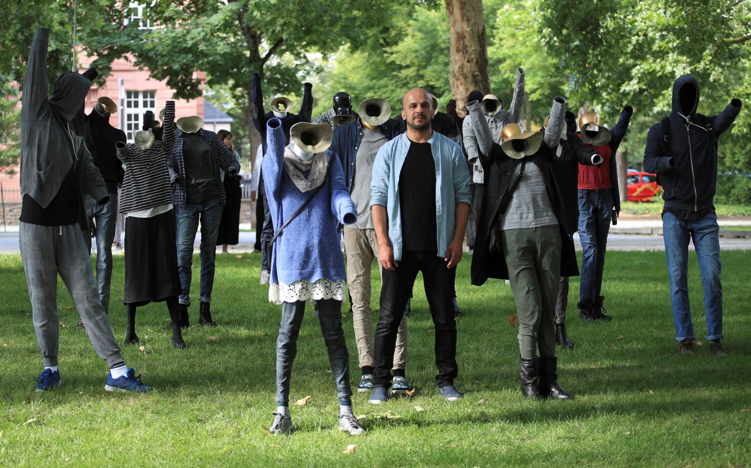 Syrian artist Khaled Barakeh, 44, stands amid his installation "The Muted Demonstration" outside a Koblenz court during the first trial against suspected members of Syrian President Bashar al-Assad's security services for crimes against humanity, in Koblenz, Germany, July 1, 2020. REUTERS/Wolfgang Rattay