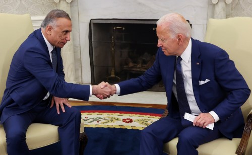U.S. President Joe Biden greets Iraq's Prime Minister Mustafa Al-Kadhimi during a bilateral meeting in the Oval Office at the White House in Washington, U.S., July 26, 2021. REUTERS/Evelyn Hockstein