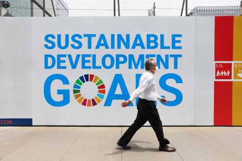 A man wearing a mask as a preventive measure against the spread of covid-19 walks past a sign advertising UN's 'Sustainable development goals' in Ginza.The State of Emergency in Tokyo will last until end of June 2021. (Photo by Stanislav Kogiku / SOPA Images/Sipa USA)No Use Germany.