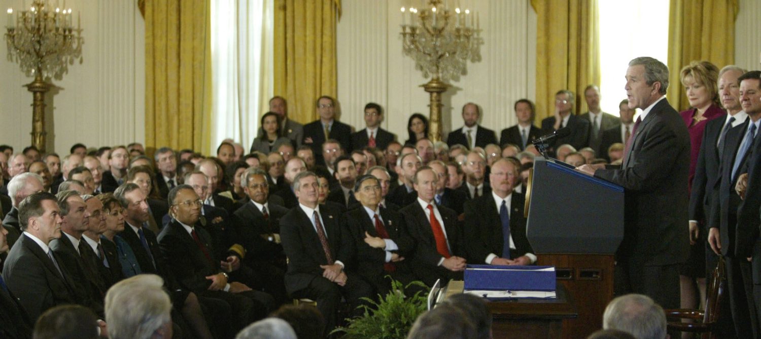 U.S. President George W. Bush (R) speaks during a signing ceremony tocreate the Department of Homeland Security in Washington, November 25,2002. White House advisor Tom Ridge (L), Asa Hutchinson (2nd L), thehead of the Drug Enforcement Administration and Navy Secretary GordonEngland (3rd L) listen to the President. Bush picked Ridge to be thedepartment's first secretary and said he would nominate England to bethe deputy secretary and Hutchinson to be undersecretary of border andtransportation security. REUTERS/Gary HershornGMH/ME