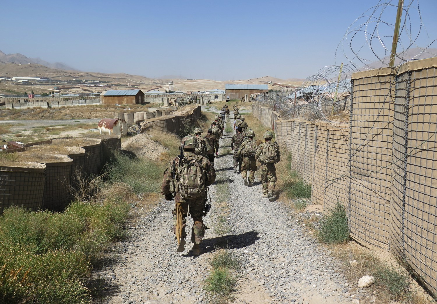 U.S. military advisers from the 1st Security Force Assistance Brigade walk at an Afghan National Army base in Maidan Wardak province, Afghanistan August 6, 2018. Picture taken August 6, 2018. REUTERS/James Mackenzie