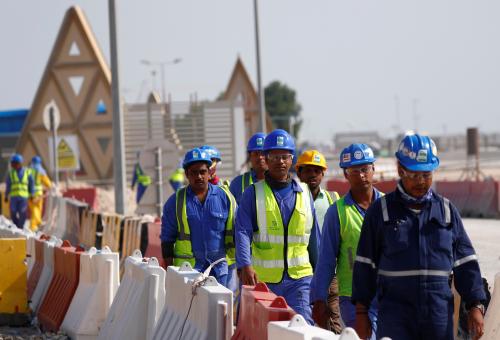 Workers walk towards the construction site of the Lusail stadium which will be build for the upcoming 2022 Fifa soccer World Cup during a stadium tour in Doha, Qatar, December 20, 2019.  REUTERS/Kai Pfaffenbach