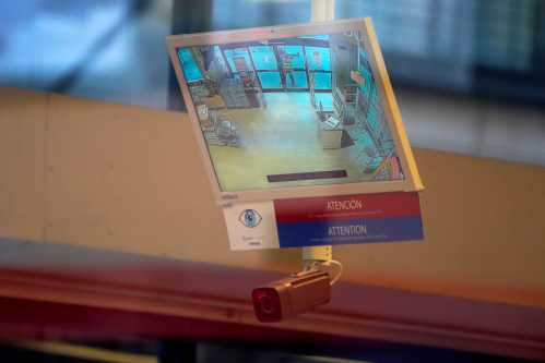 A facial recognition camera is shown pointed at the entrance of a store.