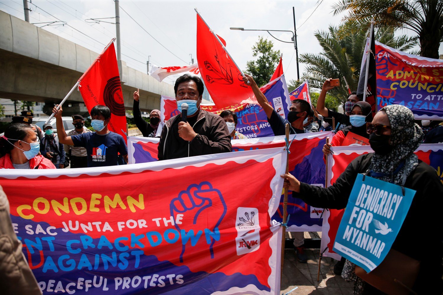 Activists hold placards and banners during a protest to support the anti-coup movement and democracy in Myanmar, near the Association of Southeast Asian Nations (ASEAN) secretariat building, ahead of the ASEAN leaders' meeting in Jakarta, Indonesia April 24, 2021. REUTERS/Willy Kurniawan