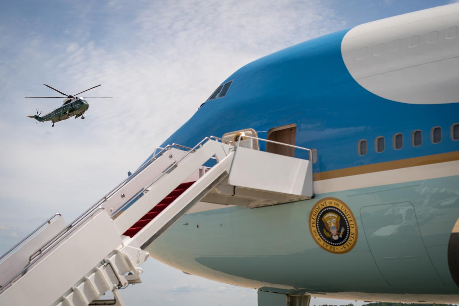Marine One arrives at Joint Base Andrews, Maryland as Air Force One waits on the tarmac for President Joe Biden.