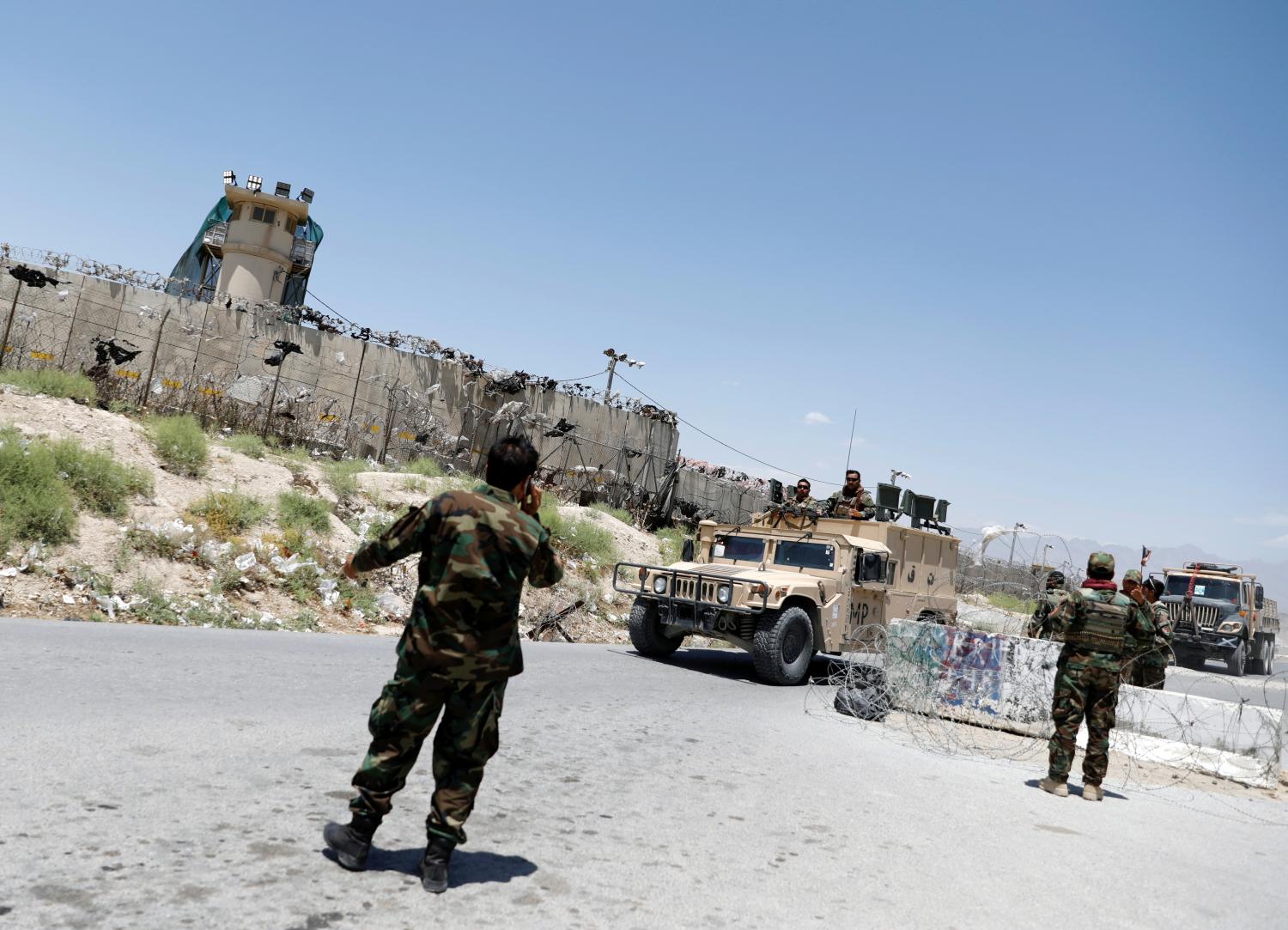 Afghan soldiers stand guard at a checkpoint outside the U.S Bagram air base, on the day the last of American troops vacated it, Parwan province, Afghanistan July 2, 2021.REUTERS/Mohammad Ismail