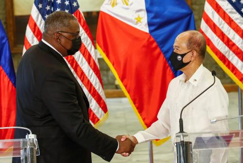 United States Defense Secretary Lloyd Austin (L) and Philippines' Defense Secretary Delfin Lorenzana (R) shake hands after a bilateral meeting at Camp Aguinaldo military camp in Quezon City, Metro Manila, Philippines, July 30, 2021. Rolex Dela Pena/Pool via Reuters