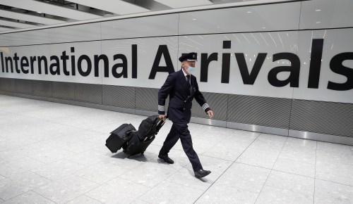 A British Airways captain walks through the International arrivals area of Terminal 5 at London's Heathrow Airport, Britain, August 2, 2021.  REUTERS/Peter Nicholls