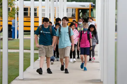 School in Tuscaloosa City and County is back in session. The new Northport Intermediate School opened its doors for the first time to students Thursday, Aug. 12, 2021.Students arriving by bus walk down a covered entryway. [Staff Photo/Gary Cosby Jr.]First Day Of School Northport Intermediate