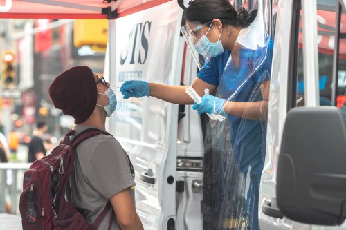 A person has a nasal swab applied for the coronavirus disease (COVID-19) test taken at a mobile testing site in Times Square in New York City, U.S., August 16, 2021. REUTERS/Jeenah Moon