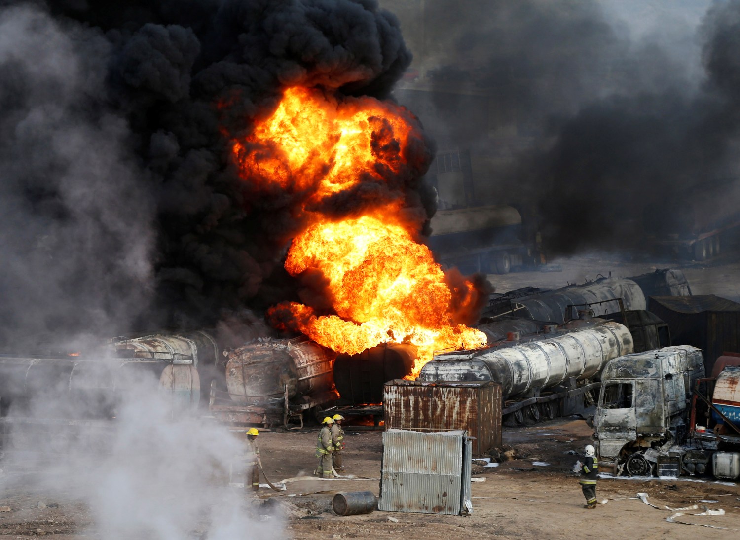 FILE PHOTO: Smoke and flames rise from fuel trucks after an overnight attack by the Taliban on the outskirts of Kabul July 5, 2014./File Photo