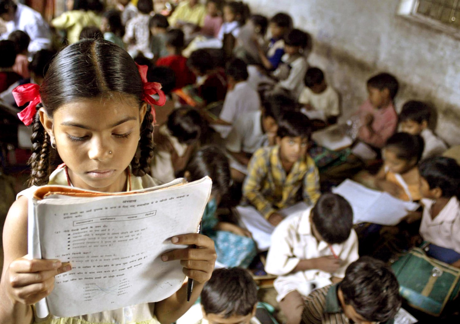 An Indian school girl reads her book inside her class at a government-run school in village Kurana on the outskirts of the Indian central city of Bhopal in this picture taken on August 24, 2004. Although India has some of the best engineering and medical schools in the world and also one of the largest pools of scientists, nearly 40 percent of Indians are still illiterate. Picture taken on August 24, 2004. TO ACCOMPANY FEATURE INDIA-EDUCATION REUTERS/Raj Patidar  AH/CP