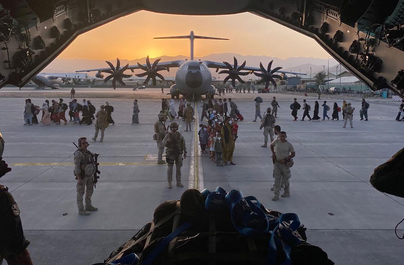 Afghan collaborators, their families, Spanish soldiers and members of the embassy board a Spanish military plane as part of their evacuation, at the Hamid Karzai International Airport in Kabul, Afghanistan, August 27, 2021. Ministry of Defense of Spain/Handout via REUTERS THIS IMAGE HAS BEEN SUPPLIED BY A THIRD PARTY. MANDATORY CREDIT. NO RESALES. NO ARCHIVES.