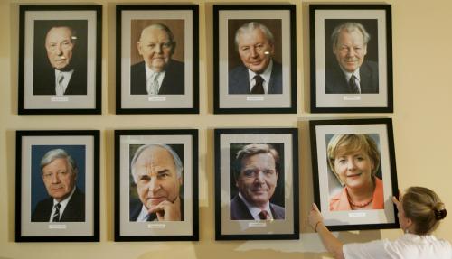 Restaurant manager Angelika Meixner places a portrait of new German Chancellor Angela Merkel beside pictures of her predecessors on a wall at the restaurant 'Kanzlereck' ('Chancellors Corner') in Berlin's government district, November 23, 2005. The pictures show (top row from L) Konrad Adenauer (German Chancellor from 1949 to 1963), Ludwig Erhardt (1963-1966), Kurt Georg Kiesinger (1966-1969), Willy Brandt (1969-1974) (lower from L) Helmut Schmidt (1974-1982), Helmut Kohl (1982-1998), Gerhard Schroeder (1998-2005) and Merkel (2005-).