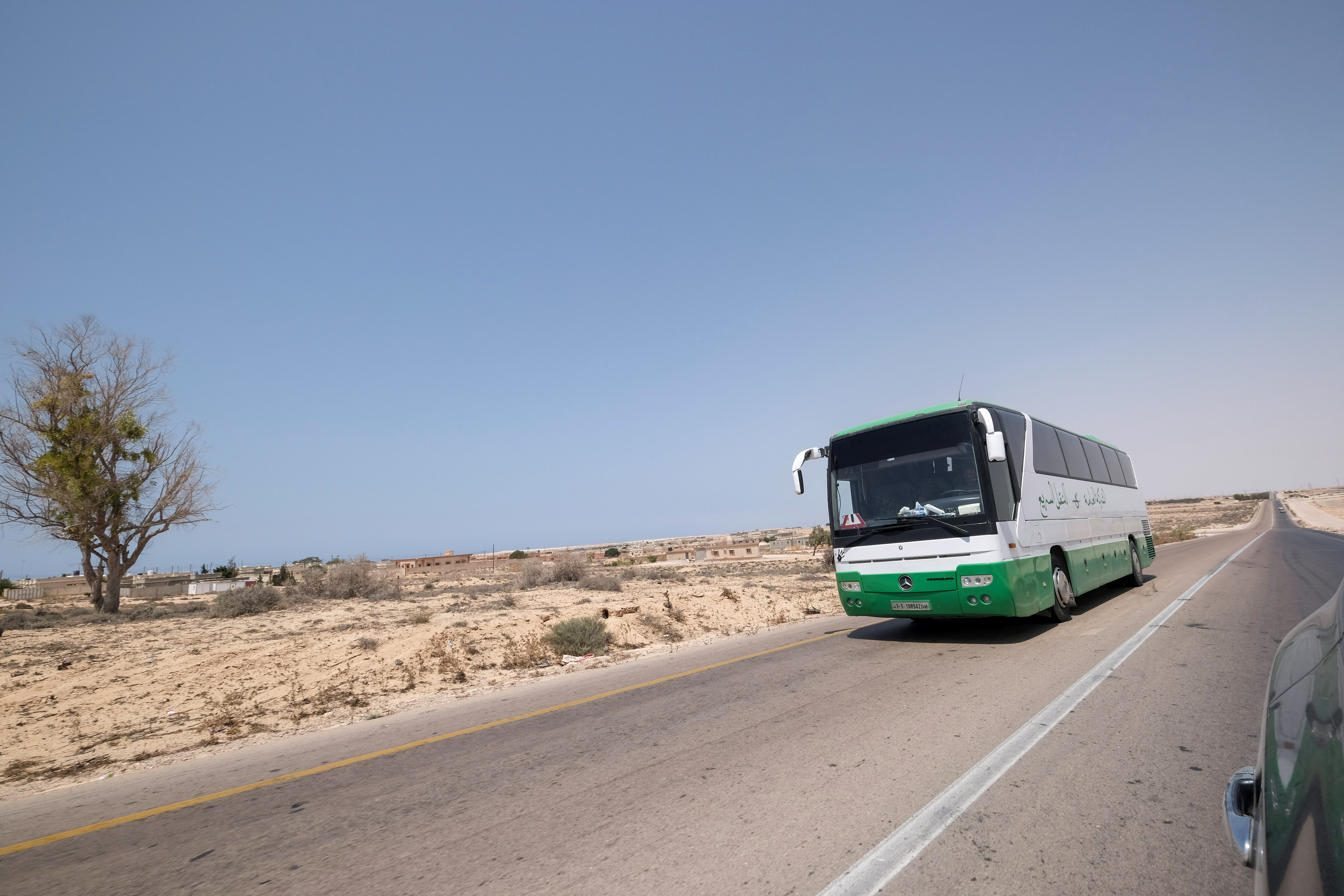 A bus travels towards Tripoli by the newly-reopened coastal road which was cut between the cities of Misrata and Sirte, near Ras Lanuf, Libya August 10, 2021. Picture taken August 10, 2021.  REUTERS/Esam Omran Al-Fetori