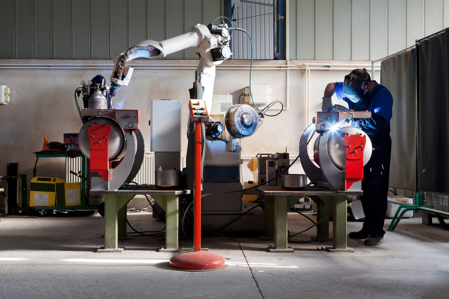 Man and robotic machine work together