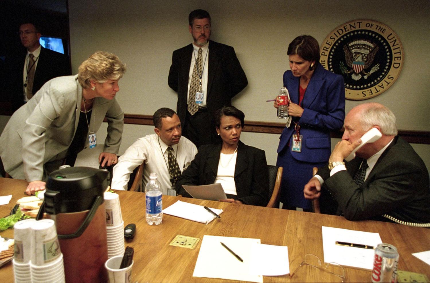 U.S. Vice President Dick Cheney (R) speaks to President George W. Bushby phone inside the operations center at the White House with staff,September 11, 2001, the day of the terror attacks in New York andWashington. Bush on September 16, 2001 asked "horrified" Americans togo back to work this week, cautioning them to be alert for more attacksand to brace for a long crusade to "rid the world of evildoers".Picture released by the White House on September 16. REUTERS/WHITEHOUSE photo by David BohrerME