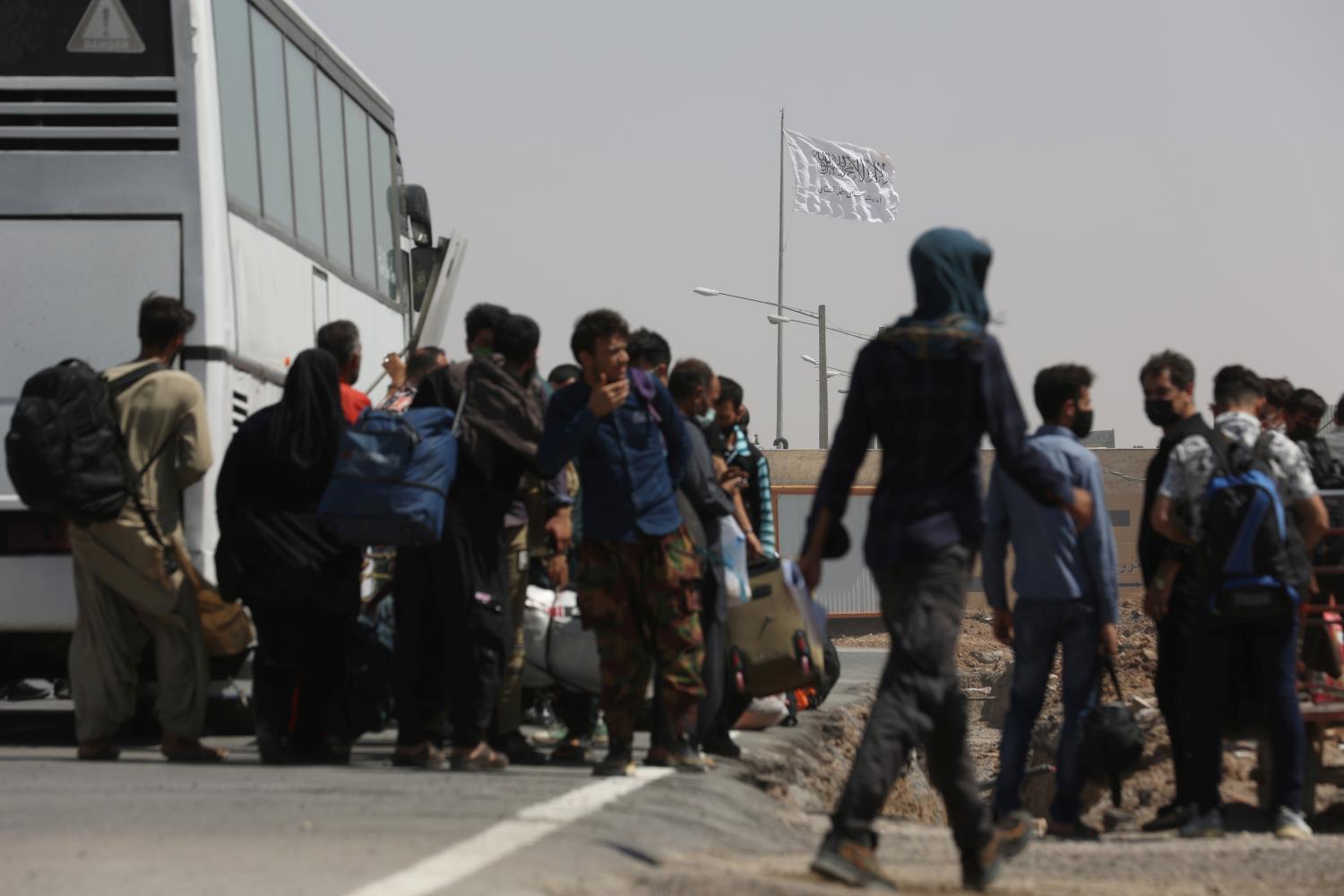 The flag of the Islamic Emirate of Afghanistan (Taliban) is pictured from the Dowqarun border crossing between Iran and Afghanistan, Razavi Khorasan Province, Iran August 29, 2021. Majid Asgaripour/WANA (West Asia News Agency) via REUTERS