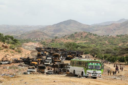 Villagers return from a market to Yechila town in south central Tigray walking past scores of burned vehicles, in Tigray, Ethiopia, July 10, 2021. REUTERS/Giulia Paravicini