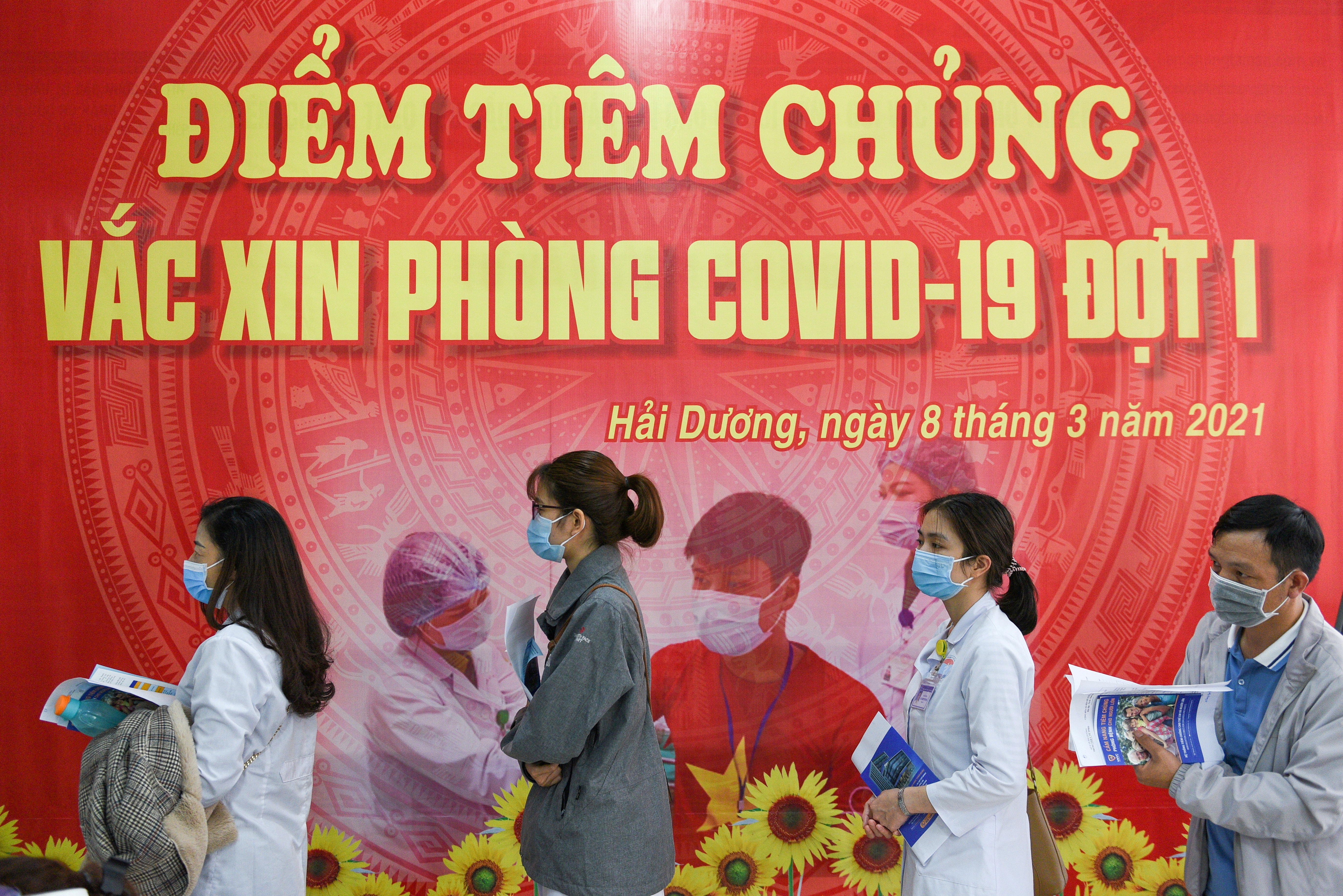 FILE PHOTO: Health workers wait for their turn as Vietnam starts its official rollout of AstraZeneca's coronavirus disease (COVID-19) vaccine for health workers, at Hai Duong Hospital for Tropical Diseases, Hai Duong province, Vietnam, March 8, 2021. REUTERS/Thanh Hue/File Photo/File Photo/File Photo