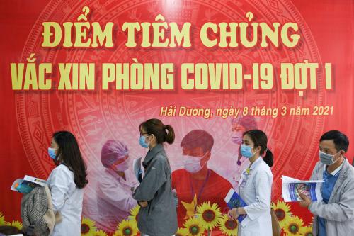 FILE PHOTO: Health workers wait for their turn as Vietnam starts its official rollout of AstraZeneca's coronavirus disease (COVID-19) vaccine for health workers, at Hai Duong Hospital for Tropical Diseases, Hai Duong province, Vietnam, March 8, 2021. REUTERS/Thanh Hue/File Photo/File Photo/File Photo