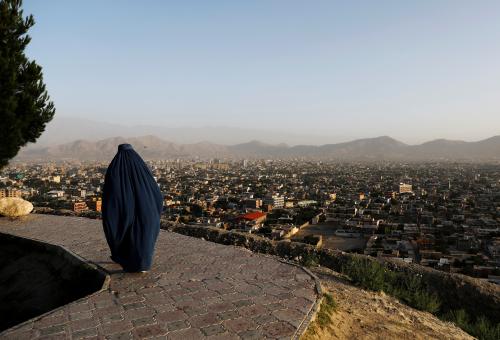 An Afghan woman walks on a hilltop overlooking Kabul, Afghanistan June 25, 2018.REUTERS/Mohammad Ismail