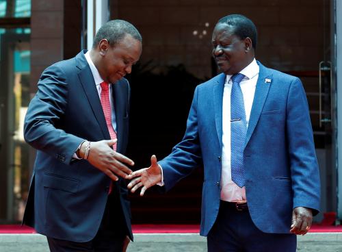 Kenya's President Uhuru Kenyatta (L) greets opposition leader Raila Odinga of the National Super Alliance (NASA) coalition after addressing a news conference at the Harambee house office in Nairobi, Kenya March 9, 2018. REUTERS/Thomas Mukoya