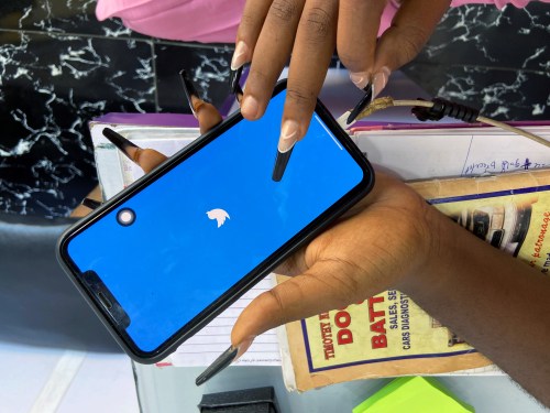 Lagos based entreprenuer Ogechi Egemonu opens the Twitter app on a smart phone at her office in Lagos, Nigeria June 10, 2021. Picture taken June 10, 2021. REUTERS/Seun Sanni