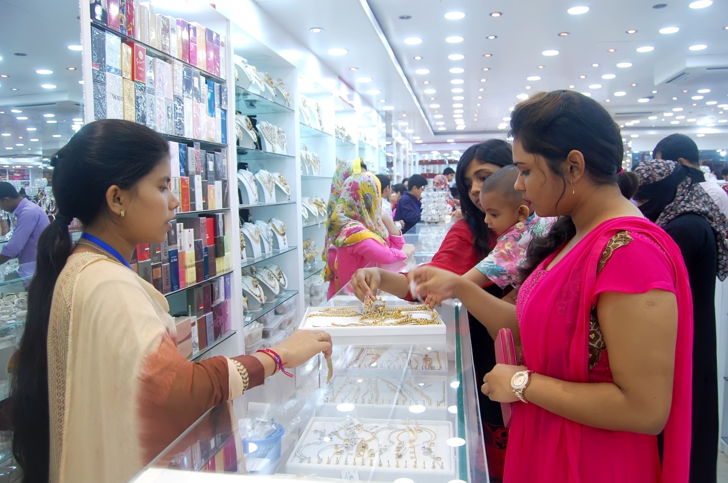 Women purchase jewelry at a shop counter in Bangladesh