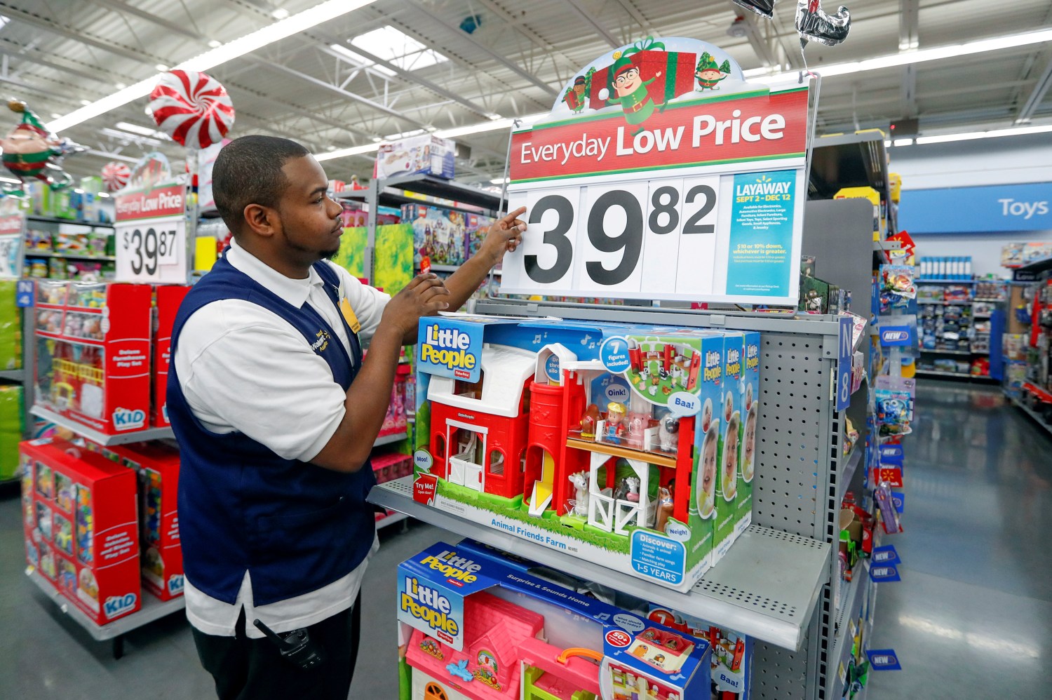 FILE PHOTO: An employee puts up a price tag ahead of Black Friday at a Walmart store in Chicago, Illinois, U.S. November 23, 2016. REUTERS/Kamil Krzaczynski/File Photo