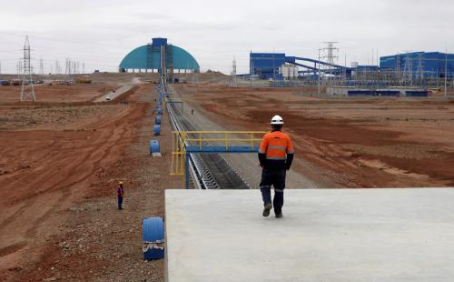 An employee looks at the Oyu Tolgoi mine in Mongolia's South Gobi region June 23, 2012. REUTERS/David Stanway/File Photo