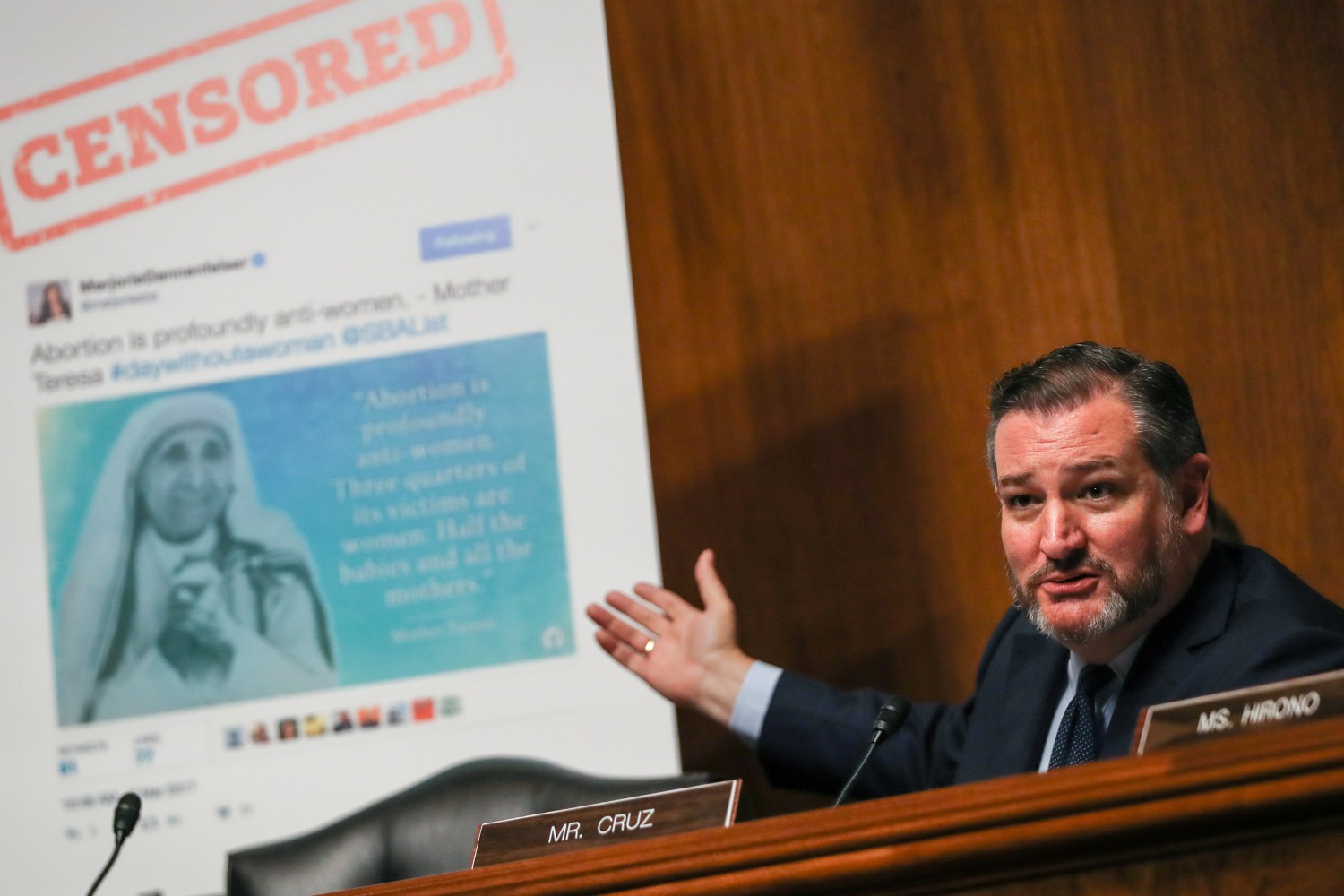 Sen. Ted Cruz gestures at a poster of a Facebook post depicting the Mother Teresa below a headline reading "CENSORED."