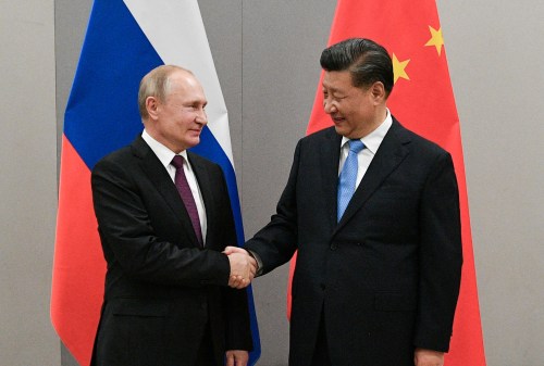 Russian President Vladimir Putin shakes hands with Chinese President Xi Jinping during their meeting on the sidelines of a BRICS summit, in Brasilia, Brazil, November 13, 2019. Sputnik/Ramil Sitdikov/Kremlin via REUTERS ATTENTION EDITORS - THIS IMAGE WAS PROVIDED BY A THIRD PARTY./File Photo