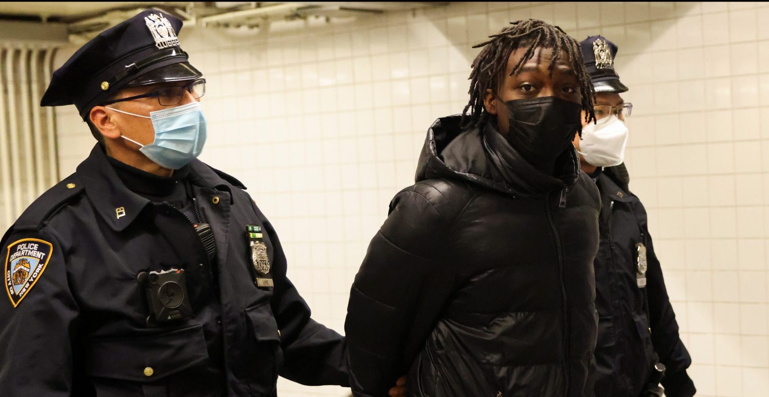 New York City Police Officers (NYPD) transport Saadiq Teague, 18, from the Columbus Circle Transit Bureau Police Station, where he was charged with two counts of criminal possession of a weapon second degree, two counts of criminal possession of a weapon in third degree; one count for the assault rifle and one for ammunition, and no one count of criminal use of drug paraphernalia after being found with an unloaded semi-automatic gun, ammunition and a gas mask outside a Times Square subway station, in New York City, U.S., April 16, 2021. REUTERS/Caitlin Ochs