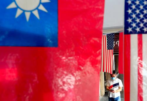 People with face masks walk past US-Taiwan which are hung outside a restaurant , amid US’s ever-changing partnership with Taiwan and the escalating tensions between Taipei and China, in Taipei, Taiwan, 10 August 2021. The US-Taiwan tie is switching to a rapport  through military, political, economy, and medical commitments and collaborations including arms sale and trade deals  whilst the intensifying threats of China unifying Taiwan have brought uncertainty to the stability of regional security for south east Asia, according to some critics. (Photo by Ceng Shou Yi/NurPhoto)NO USE FRANCE