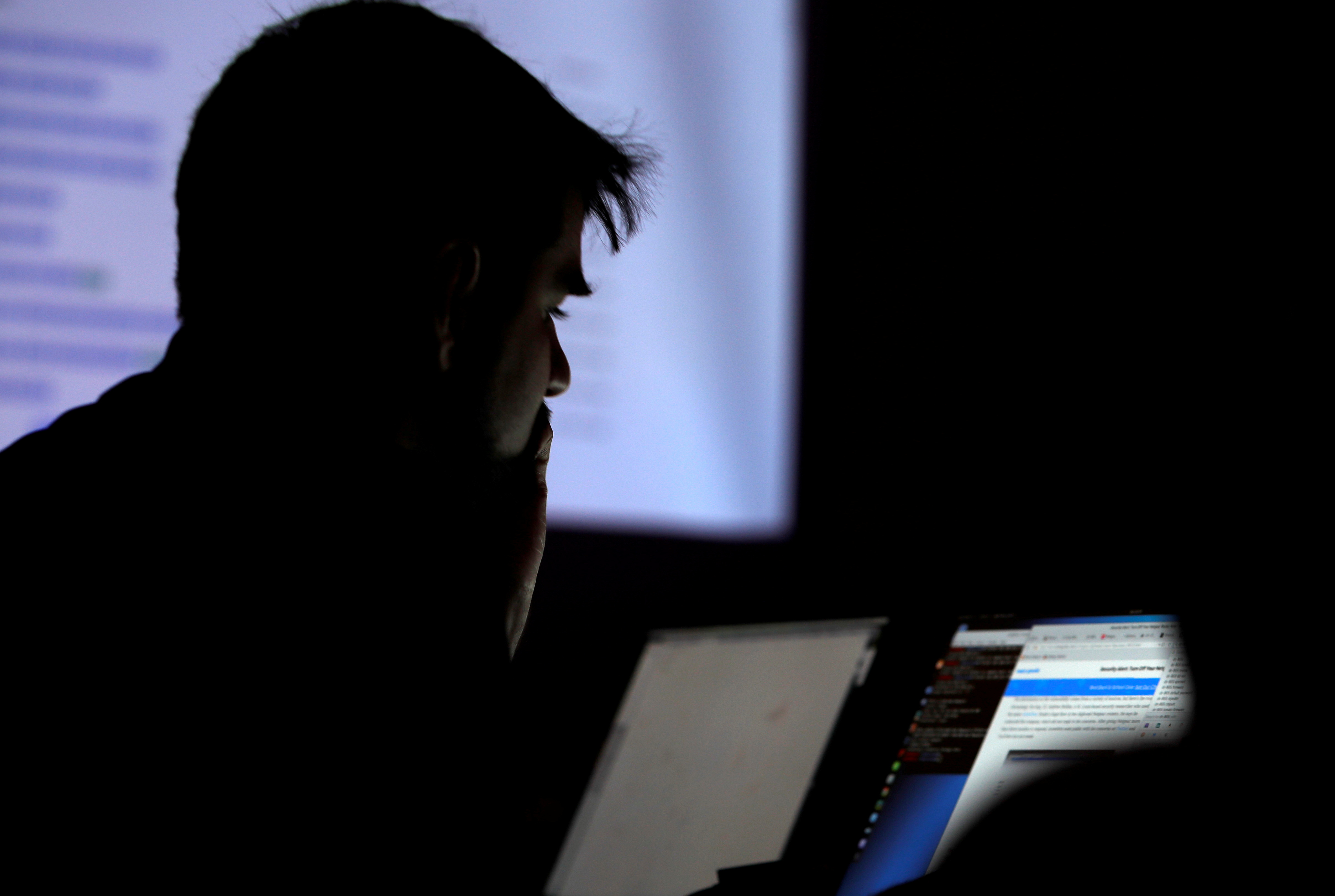 FILE PHOTO: A man takes part in a hacking contest during the Def Con hacker convention in Las Vegas, Nevada, U.S. on July 29, 2017. REUTERS/Steve Marcus/File Photo