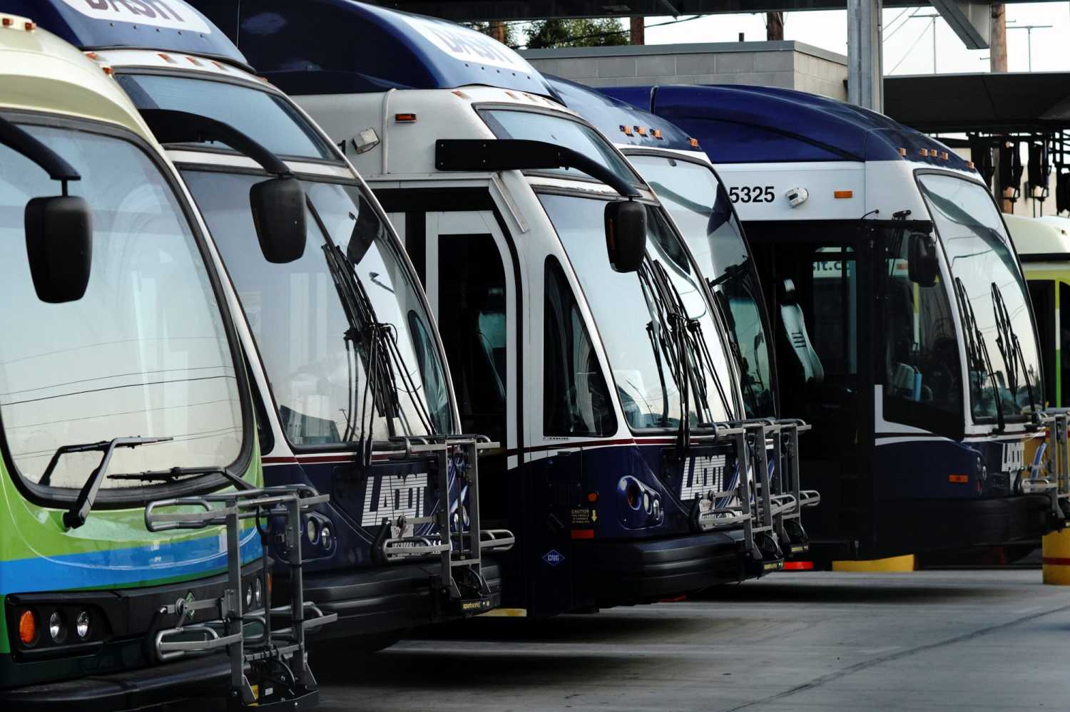 A Proterra Catalyst BE35 electric bus and CNG (compressed natural gas) buses are seen at an L.A. City Transportation Department (LADOT) DASH transit bus maintenance facility in downtown Los Angeles, California, U.S., August 21, 2021.  REUTERS/Bing Guan