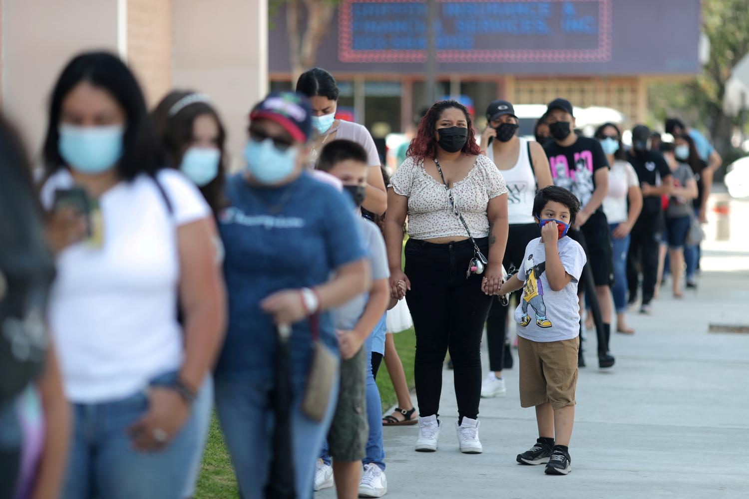 People wait in line for back to school COVID test