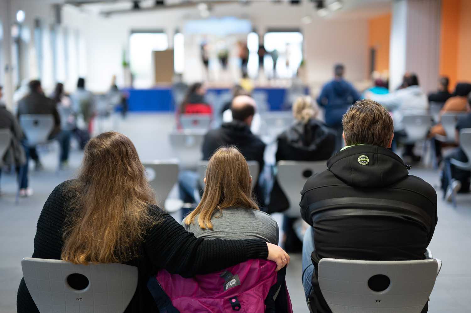 A student attends the enrollment of a fifth grade class at Alteburg School with her parents.