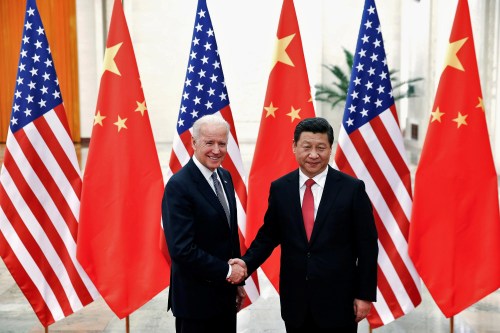 FILE PHOTO: Chinese President Xi Jinping shakes hands with then-U.S. Vice President Joe Biden (L) inside the Great Hall of the People in Beijing December 4, 2013. REUTERS/Lintao Zhang/Pool/File Photo