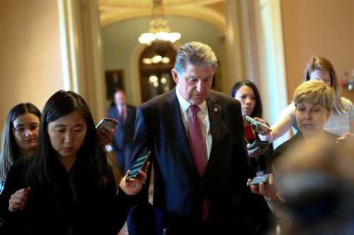 FILE PHOTO: Senator Joe Manchin (D-WV) speaks to news reporters before attending a meeting on infrastructure on Capitol Hill in Washington, U.S., June 23, 2021.  REUTERS/Tom Brenner/File Photo