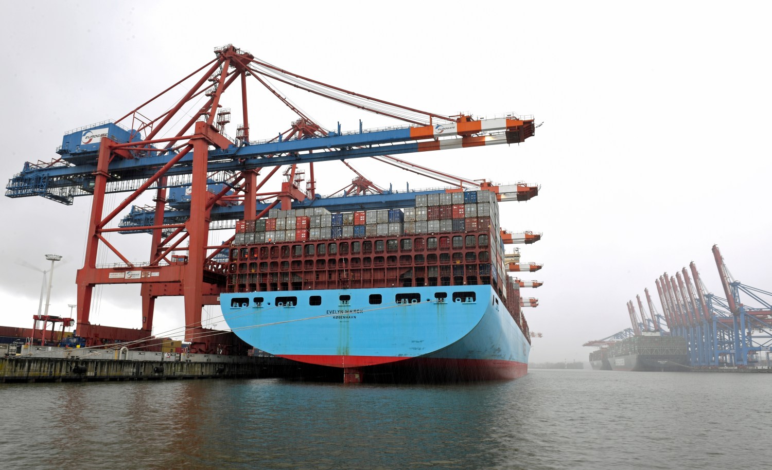 Container ship "Evelyn Maersk" is loaded during snowfall at a container terminal in a harbour amid the coronavirus disease pandemic.